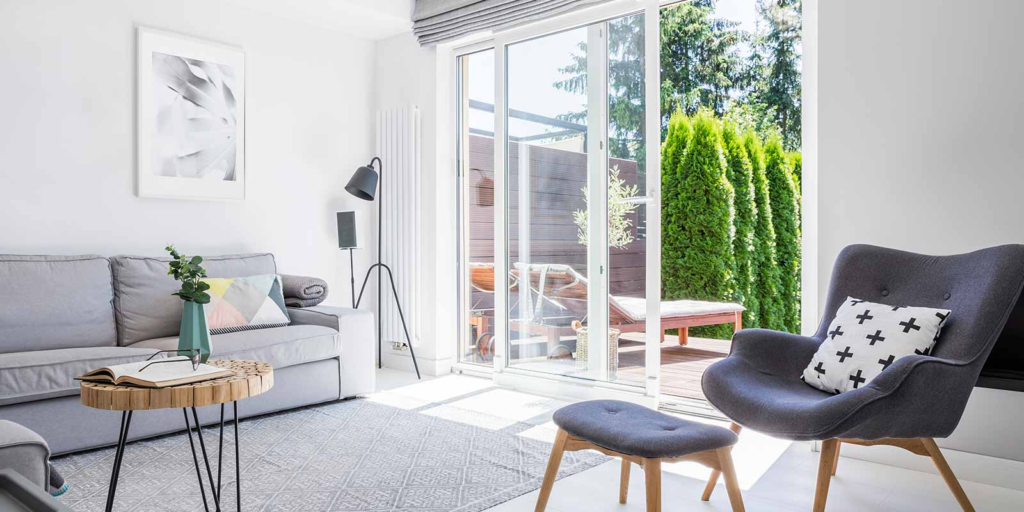 Bright living room opening onto a patio through sliding glass doors