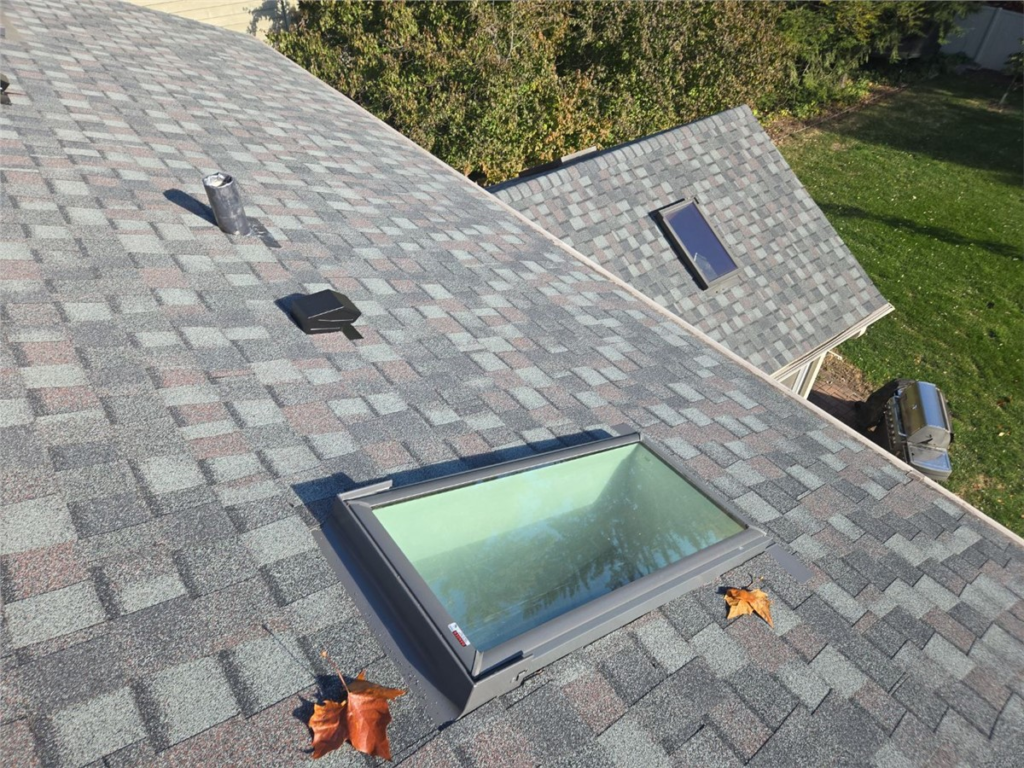 Replacement skylight installed on an asphalt shingle roof