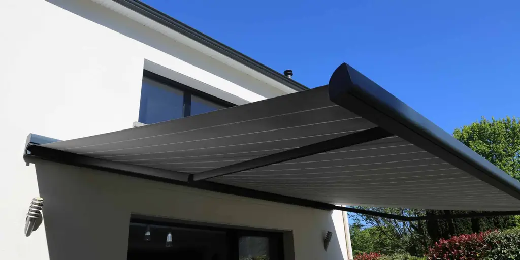 Retractable awning extended over a patio on a modern home
