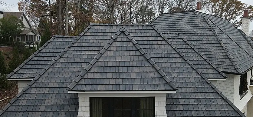 Close-up of a gray DaVinci synthetic roof on a hip-roof home